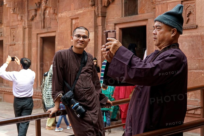 Man taking photos with smartphone in historical surroundings, Agra, Jodhpur, Rajasthan, North India