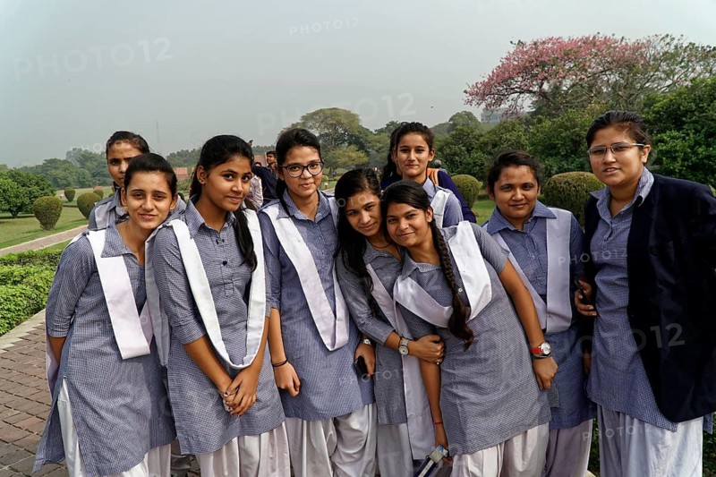 Agra, Jodhpur, Rajasthan, North India, Asia, A group of cheerful girls in uniforms poses smiling in a park