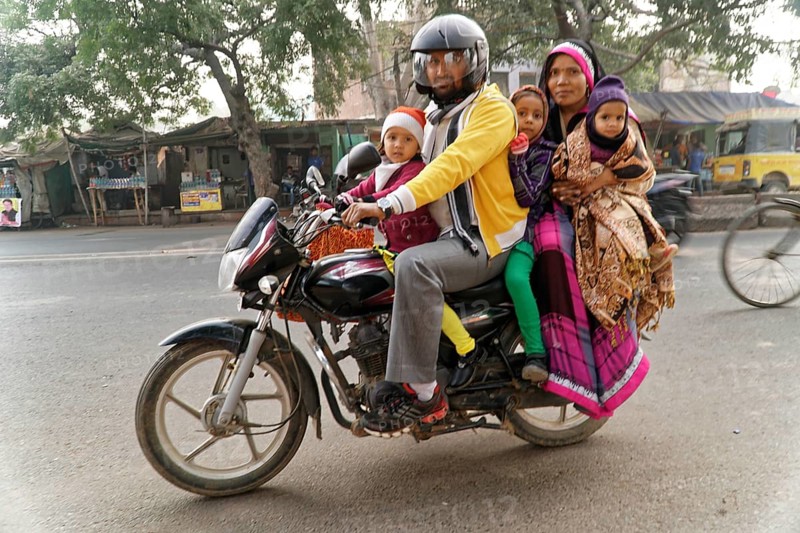 Agra, Jodhpur, Rajasthan, North India, Asia, family with three children on a motorbike on a busy street