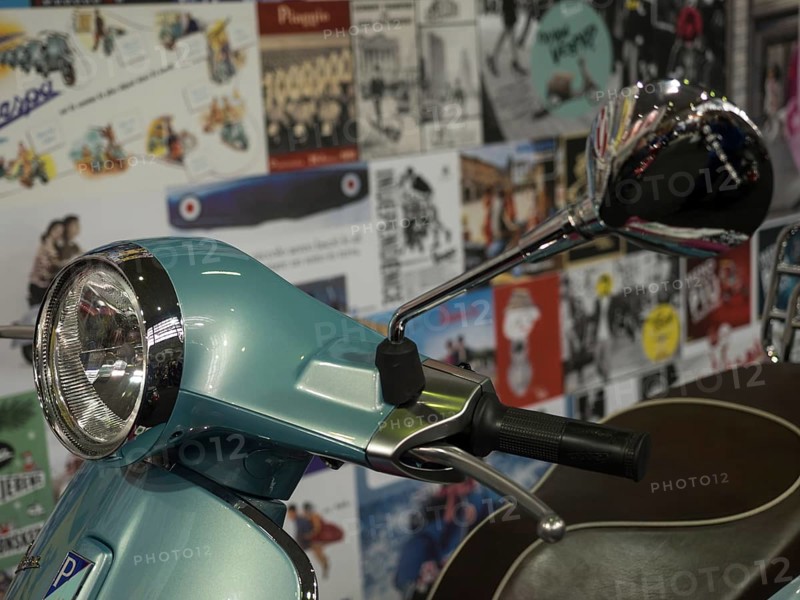 Retro scooter in blue with a chrome mirror, surrounded by billboards in the background, dortmund, deutchland