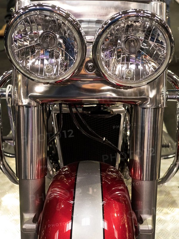 Close-up view of round chrome headlights of a motorbike with red elements, dortmund, deutchland