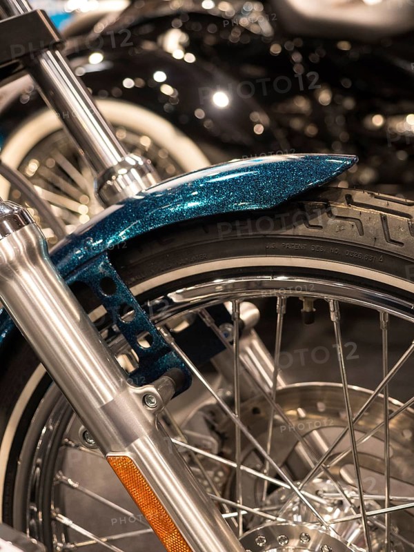 Close-up of a motorbike tyre with wire spokes and chrome rim, Dortmund, Germany