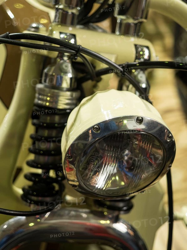 Vintage-style headlight on a cream-coloured motorbike with chrome details, dortmund, deutchland