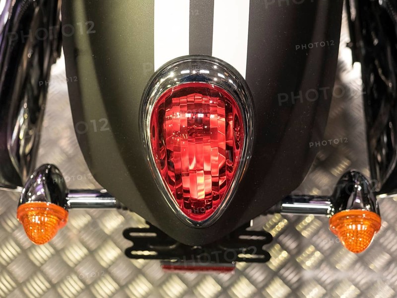 Red tail light with black stripes and orange indicators on metal base, dortmund, deutchland