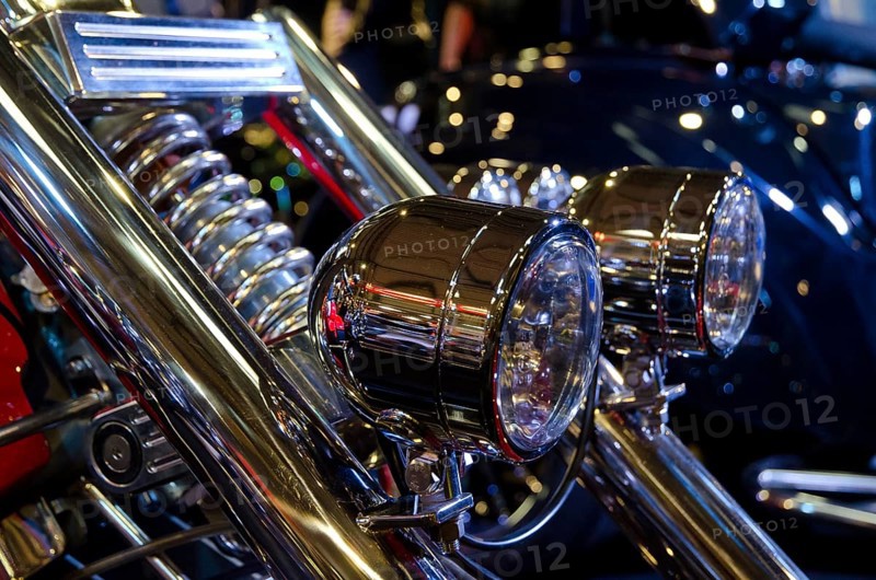 Two shining chrome headlights on a motorbike with blurred background, dortmund, germany