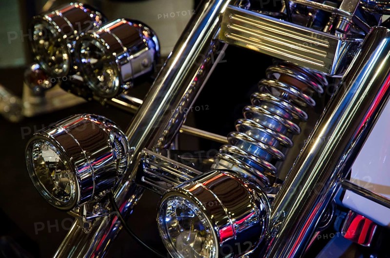 Front view of a motorbike with several shiny chrome headlights and suspension fork, dortmund, germany