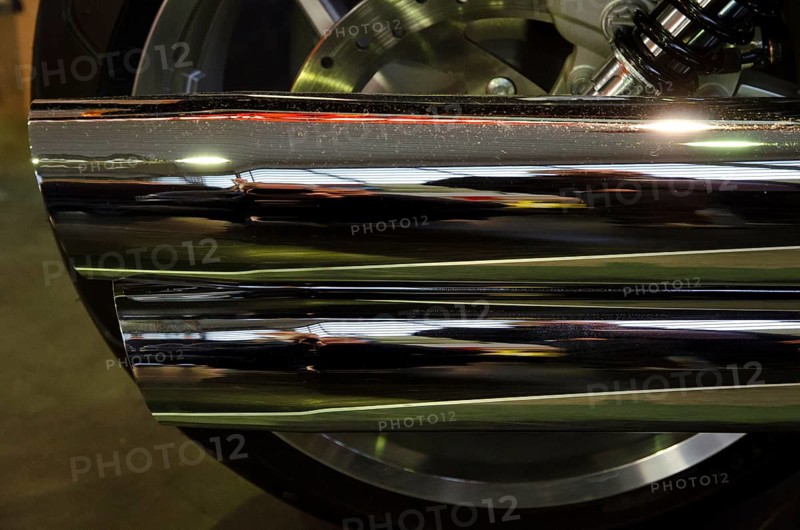 Close-up of a chrome-plated motorbike exhaust with shiny surface and reflections, dortmund, germany