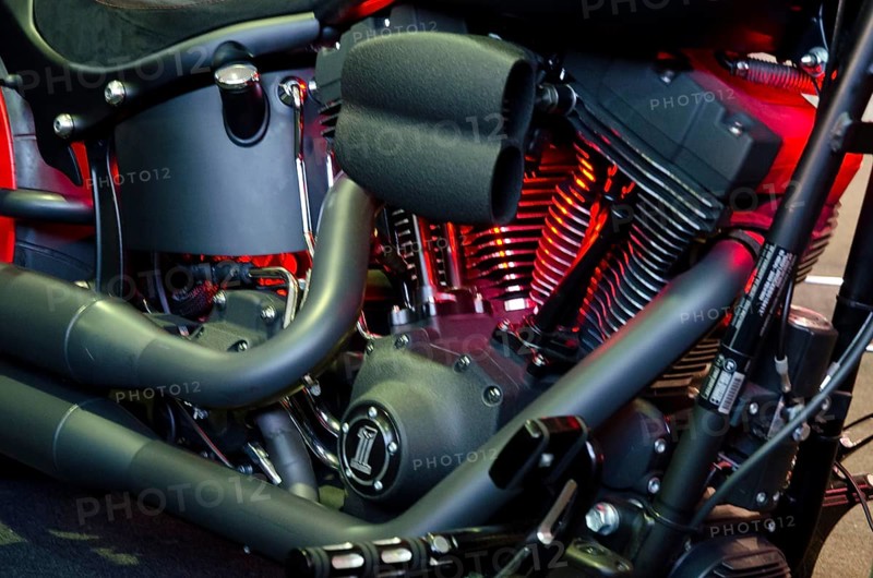 Detailed image of a motorbike engine block with red illuminated components, dortmund, germany