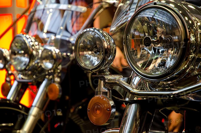 Several motorbikes with striking chrome headlights in a row, dortmund, germany
