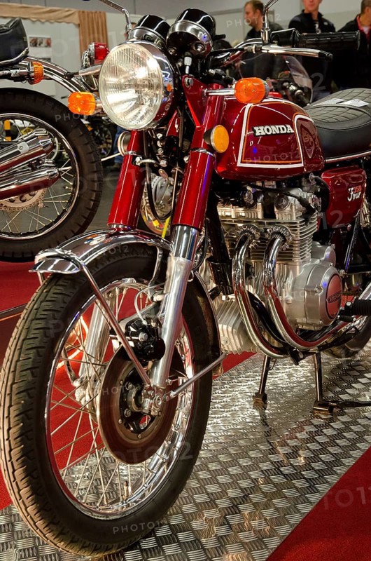 Classic red Honda motorbike with lots of chrome elements in a showroom, dortmund, germany