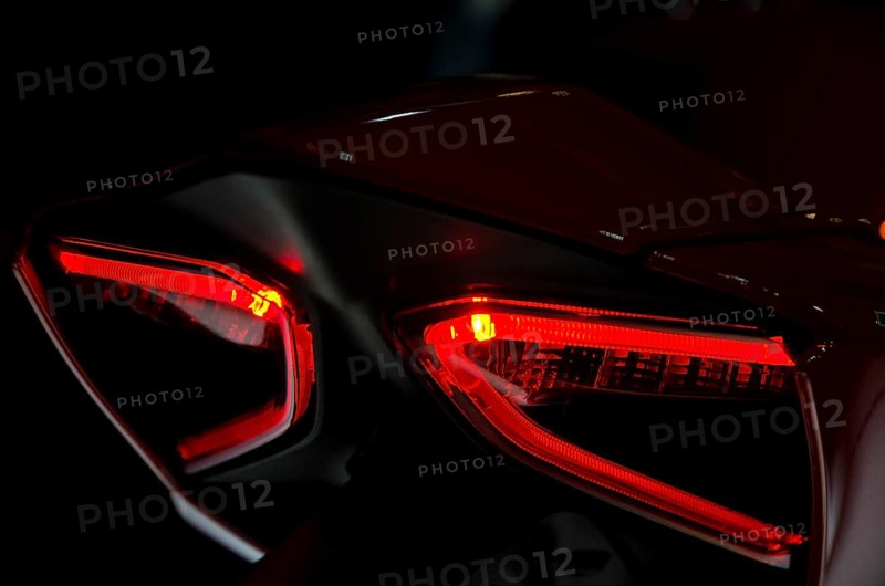 Red tail lights of a motorbike in dark surroundings, modern design, dortmund, germany