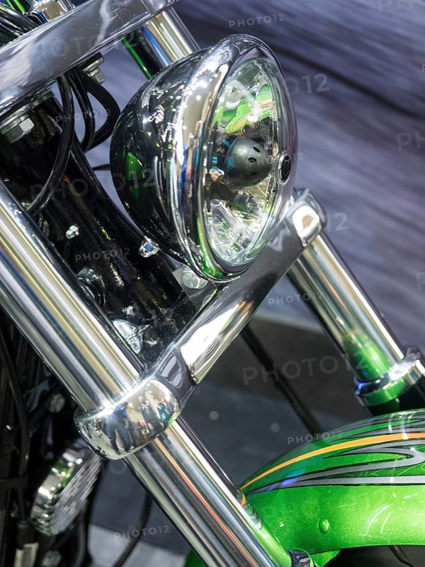 Motorbike headlight with green details and shiny chrome, dortmund, germany