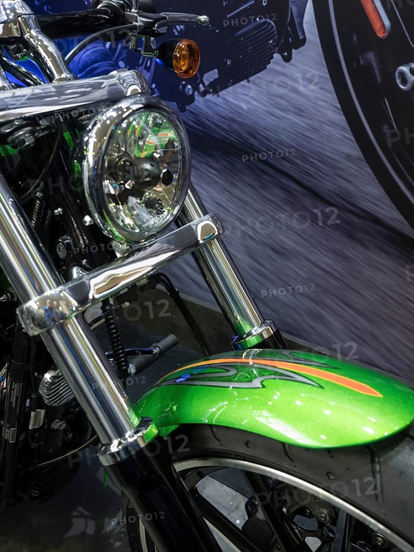 Motorbike with green and chrome accents riding down a street, dortmund, germany
