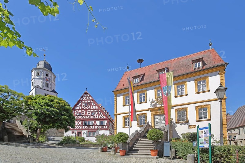 St. Nicholas Church built in 1510, cantor's house built in 1510 and baroque town hall built in 1739 with German national flag and town flag, half-timbered house, town hall square, Winterhausen, Eibelstadt, Lower Franconia, Franconia, Bavaria, Germany