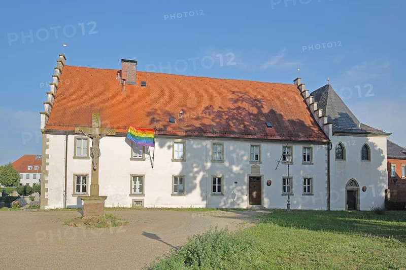 Hospital building built in the 16th century with crucifix and rainbow flag, peace flag, Lower Franconia, Franconia, Bavaria, Germany