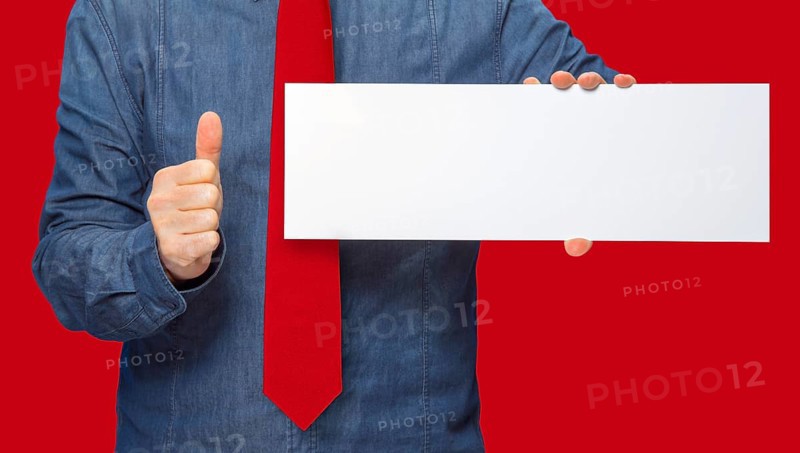 Male person holding a white blank sign in red back