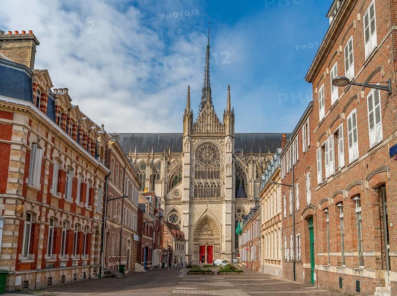 Impression of Amiens, a city and commune in northern France. It shows the Amiens Cathedral surrounded by historic house facades