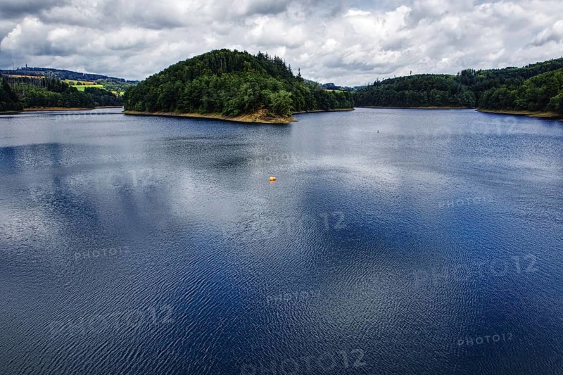 A large reservoir (Aggertalsperre) under a cloudy sky with green wooded banks, Bergneustadt