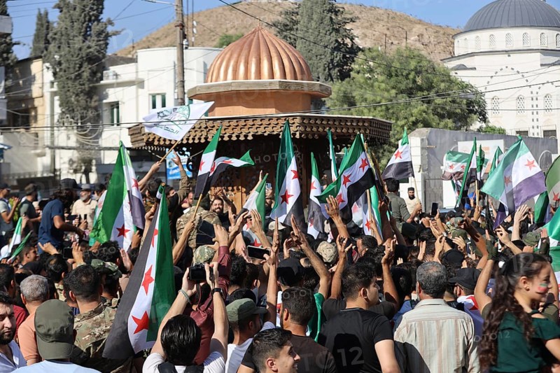 Thousands of Syrians march in Idlib carrying the Syrian revolutionary flag during a protest against international calls to normalize relations with Bashar al-Assad's regime. Aleppo, Syria. July 2, 2024, Aleppo, Aleppo, Syria