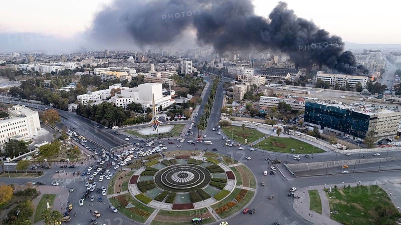 Smoke billows from Umayyad Square in Damascus following Israeli airstrikes targeting Syrian military sites on the eve of Bashar al-Assad's regime collapse and opposition takeover. Damascus, Syria. December 8, 2024, Damascus, Damascus, Syria