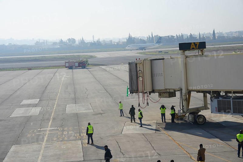 Syrians gather to welcome the first passenger plane to land at Aleppo International Airport following the fall of Bashar al-Assad's regime. Aleppo, Syria. December 18, 2024, Aleppo, Aleppo, Syria