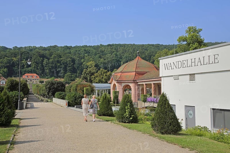 Pedestrians in the spa gardens with Wandelhalle, Wernarz spring temple and view of Fürstenhof, path, inscription, state bath, Bad Brückenau, Rhön, Bavaria, Germany
