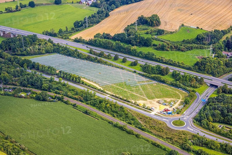 Aerial view, field with construction site for ground-mounted photovoltaic plant solar park at the motorway A46, roundabout Casparistraße, Uentrop, Arnsberg, Ruhr area, North Rhine-Westphalia, Germany, construction work, construction area, building site, building plots, construction project, construction site, DE, Europe, photovoltaic, aerial view, aerial photography, aerial photography, new construction, photovoltaic plant, solar, solar plant, solar energy, solar power plant, overview, bird's eye view, bird's eye view, overview