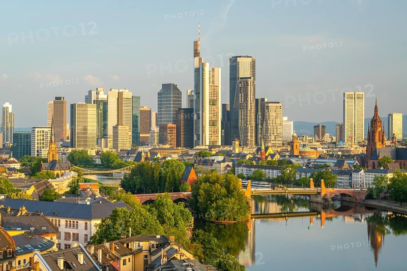Frankfurt City Skyline, Residential Buildings, Bridges and Main River on Sunny Morning. Aerial View. Golden Hour. Hesse, Germany
