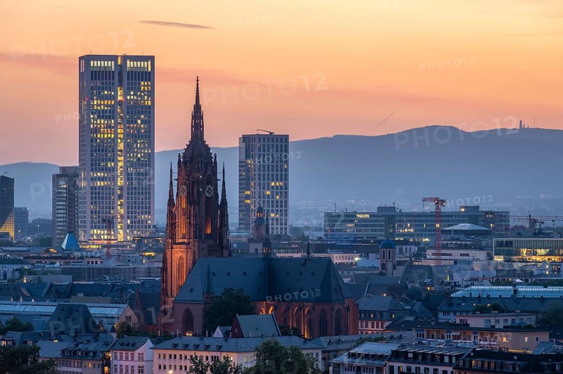 Illuminated Frankfurt Cathedral, Residential Buildings and City at Evening Twilight. Aerial View. Blue Hour. Hesse, Germany