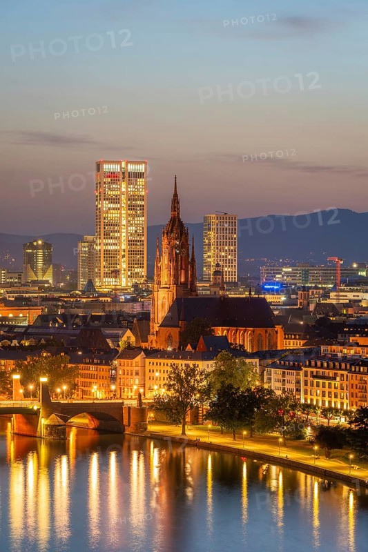 Illuminated Frankfurt Cathedral, Residential Buildings, City and Main River at Night. Aerial View. Blue Hour. Hesse, Germany