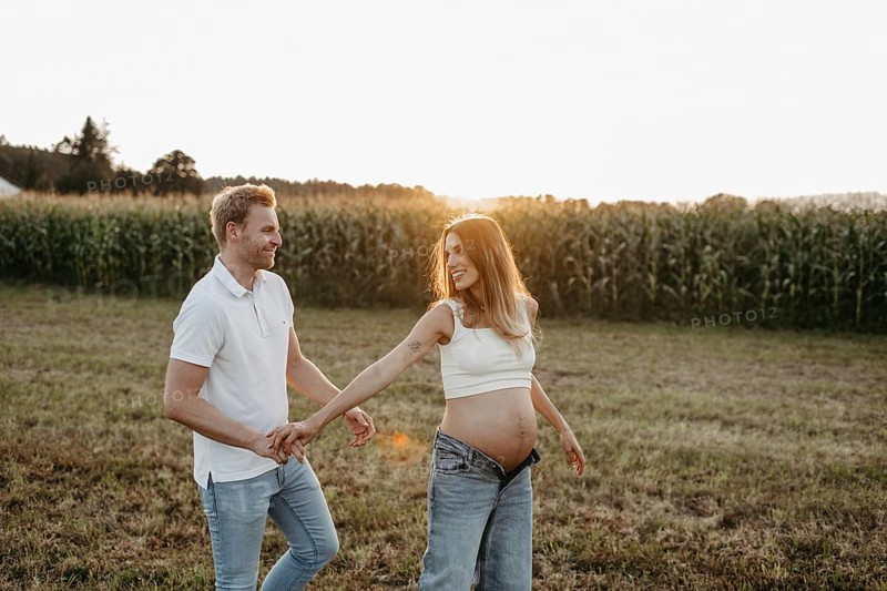 Pregnant, young woman with partner