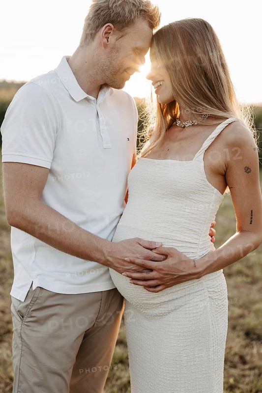 Pregnant, young woman with partner
