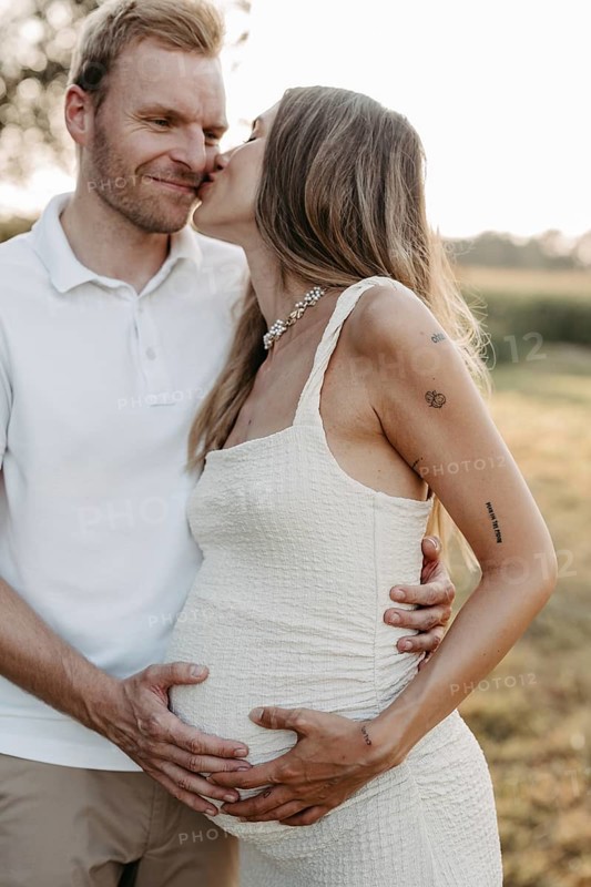 Pregnant, young woman with partner