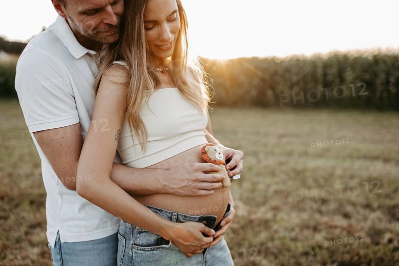 Pregnant, young woman with partner