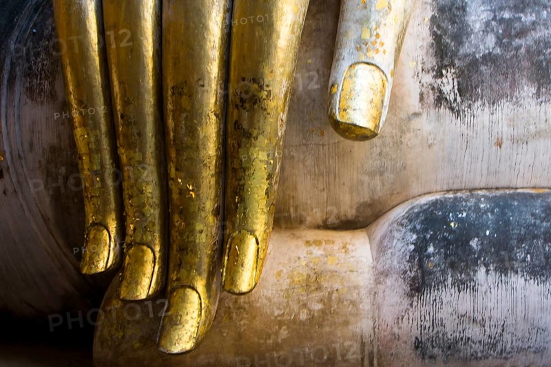 Golden Buddha finger in the temple Wat Si Chum in Sukhothai