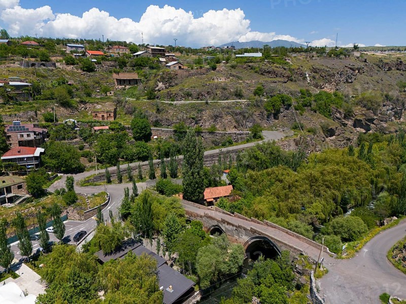 Idyllic village landscape amidst hills, near a river, with clear clouds in the sky, aerial view, Triple arch bridge over the Kassagh river from 1664, Ashtarak bridge, Ashtarak, Aštarak, Aragazotn province, Armenia