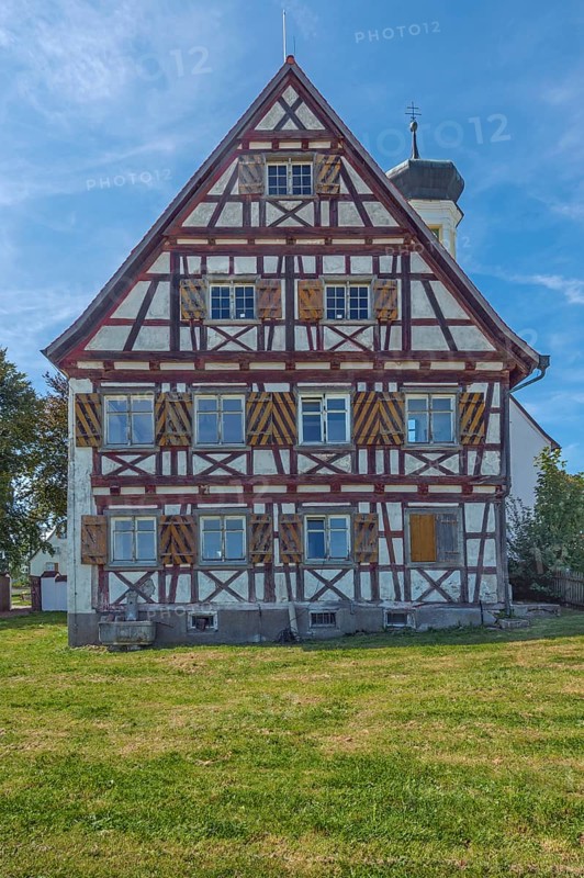 Pointed gable façade with half-timbering next to the hospital chapel in Bärenweiler from 1619 near Kisslegg, Allgäu, Baden-Württemberg, Germany