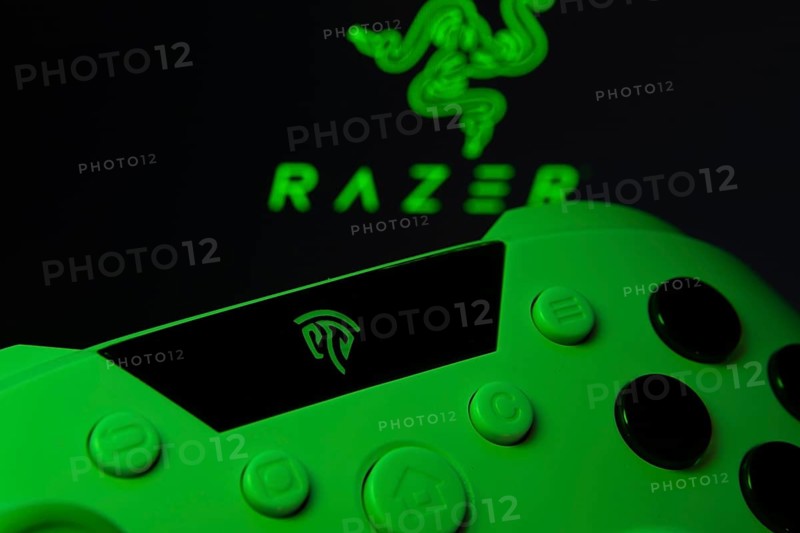 Dhaka, Bangladesh- 13 Sep 2025: A close-up of a gamepad with the Razer seen on screen in the background