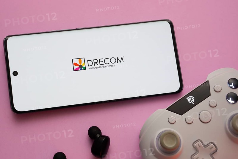 Dhaka, Bangladesh- 13 Sep 2025: A close-up of a gamepad with the Drecom seen on smartphone
