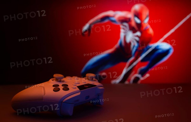 Dhaka, Bangladesh- 13 Sep 2025: Game controller in front of Marvel's Spider Man on a background