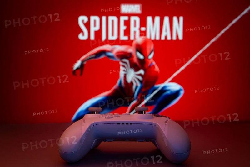 Dhaka, Bangladesh- 13 Sep 2025: Game controller in front of Marvel's Spider Man on a background