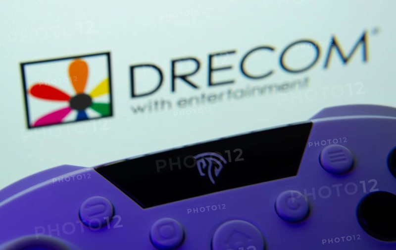 Dhaka, Bangladesh- 12 June 2025: A close-up of a gamepad with the Drecom seen on screen in the background