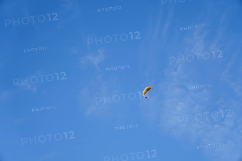 Paragliding on a sunny day with cirrus clouds, enjoying freedom and adventure in ronda, malaga, spain