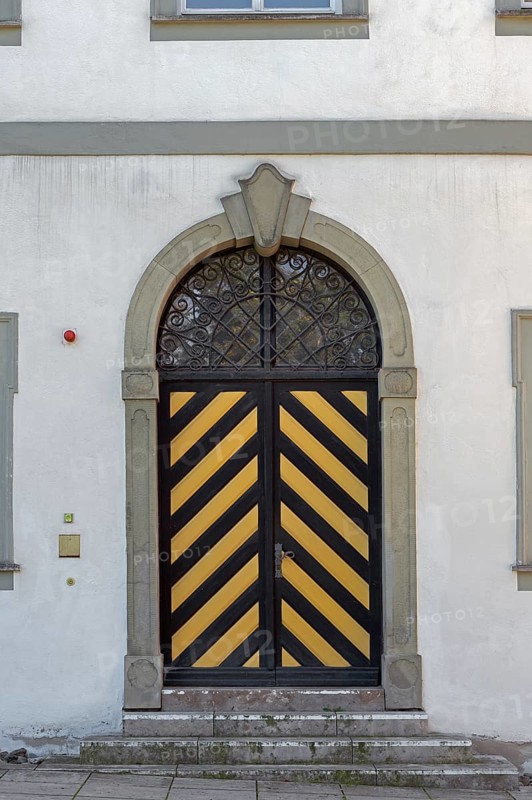 West façade with wooden gate and iron grille, New Castle in Kisslegg, Allgäu, Baden-Württemberg, Germany