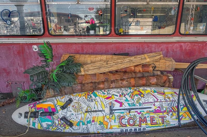 A rail bus from the 1950s is being renovated at the Spatz youth centre, with a pop-painted surfboard in front of it, Kisslegg, Allgäu, Baden-Württemberg, Germany