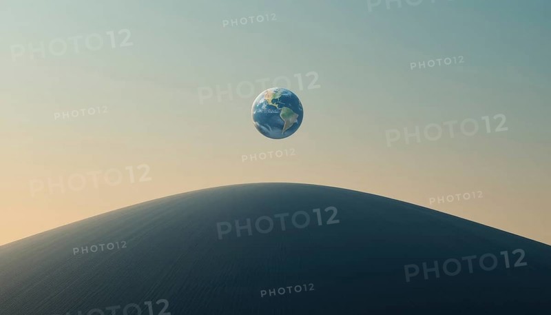 A surreal image shows planet Earth suspended in the sky above a large sand dune, evoking a sense of wonder and environmental themes, AI generated