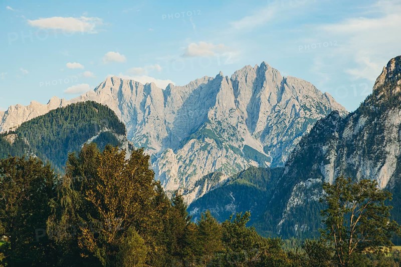 Imposing mountain peaks, Hochtor and Großer Ödstein, rise above wooded hills, Weng im Gesäuse, Styria, Austria