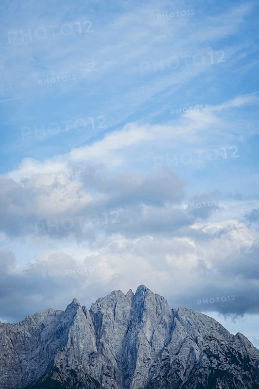 Imposing mountain peak of the Ödstein against a cloudy blue sky, Gesäuse, Styria, Austria