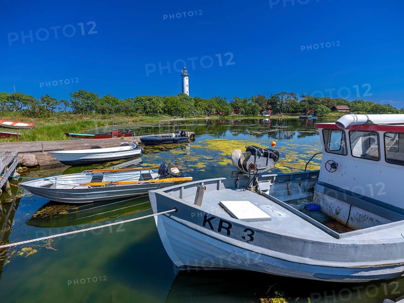 Long Erik lighthouse, Long Erik, on the northern tip of the Swedish island of Stora grundet in the Baltic Sea, wooden boats at the jetty, Stora grundet, Öland, Sweden