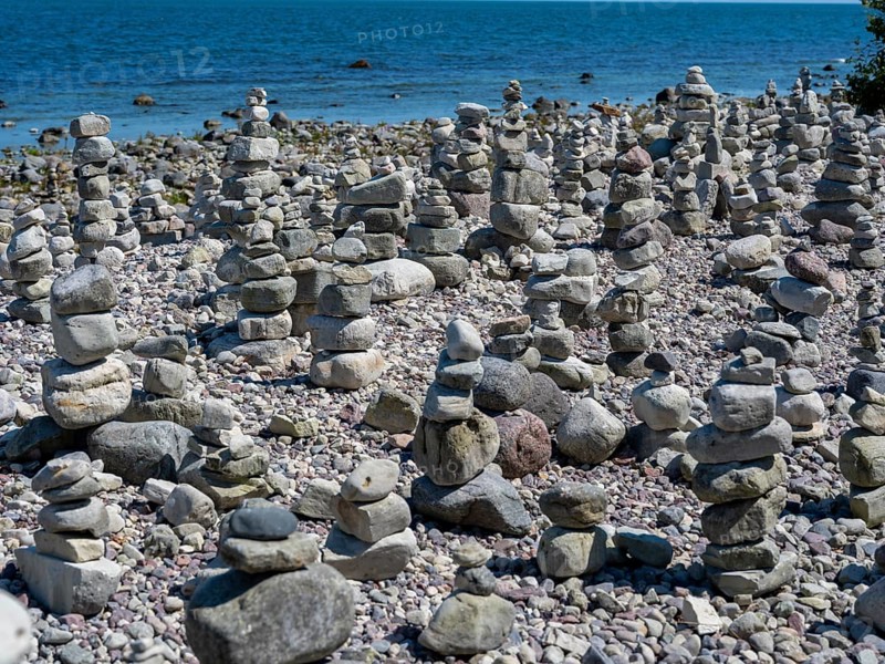 Piled stones on the shore of the island of Stora grundet on the northern tip of the Swedish island of Öland in the Baltic Sea, Öland, Sweden